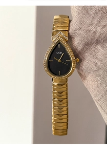 Detail of GEDI quartz watch featuring a gold teardrop dial and crystal accents