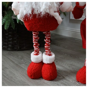 Close-up of plush Santa Claus legs with red and white striped patterns and soft red boots
