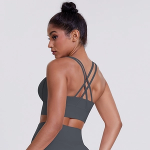 Detail of cross-strap back design on charcoal grey seamless sports bra and yoga top