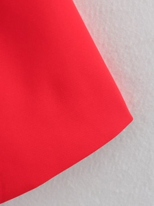 Macro shot of red plain weave fabric showing detailed material texture and fiber quality