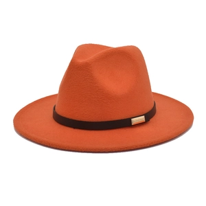Detail of orange wool fedora hat featuring a black leather band and gold buckle