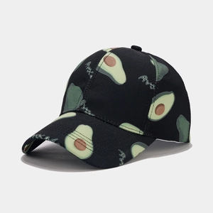 Close-up detail of the avocado print pattern and fabric texture on a black baseball cap