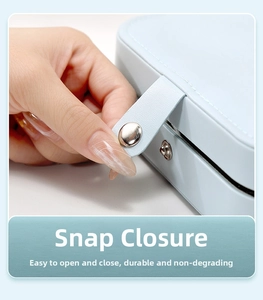 Macro detail of light blue leather jewelry box featuring a durable silver metal snap closure