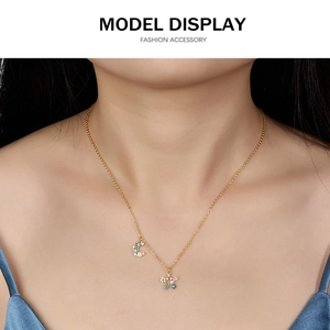 Close-up of star and moon pendant necklace with blue zircons on a model's neck