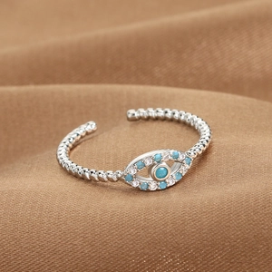 Retro Evil Eye open ring in silver with blue and white zircon stones on brown fabric