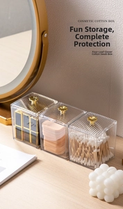 Detailed macro view of clear acrylic cotton swab box with elegant gold clover handles