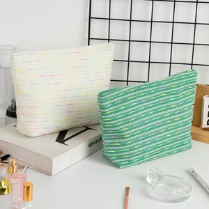 Large woven makeup bags in cream and green with colorful knit texture for women
