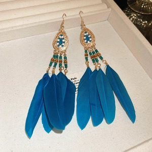 Bohemian blue feather tassel earrings with vintage gold metal and beaded detailing