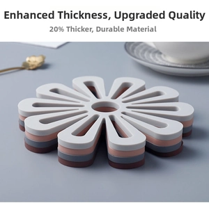 Close-up of stacked colorful daisy-shaped silicone placemats with hollow-out design