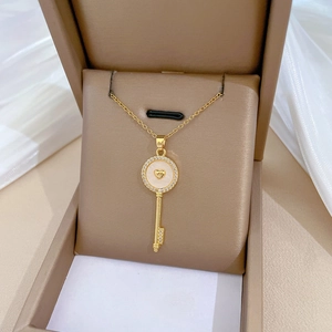 Elegant gold titanium steel shell key necklace with zircons in a brown jewelry box