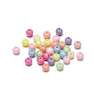 Close-up of colorful acrylic pearls with iridescent finish for DIY jewelry making