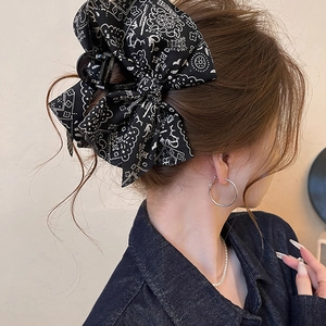 Elegant large black paisley bow hair claw clip for women with a vintage aesthetic look