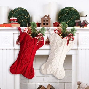 Macro shot of red and white bone-shaped knitted Christmas stockings on a fireplace