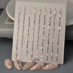 Detailed macro view of 5D white daisy nail stickers with 3D embossed floral patterns