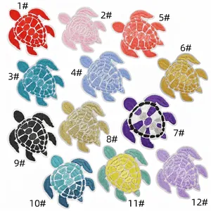 Macro detail of 12 colorful turtle embroidery patches for DIY clothing decoration