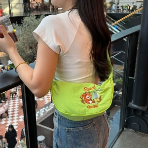 Detail of green dumpling bag featuring exquisite squirrel embroidery and durable nylon fabric