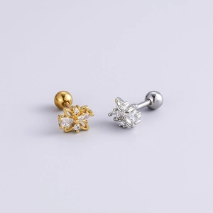 Close-up of gold and silver butterfly stud earrings with sparkling cubic zirconia stones