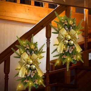 Christmas staircase swag with gold bows, pine needles and warm LED lights decoration