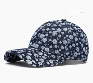 Detail of floral pattern on dark blue denim baseball cap with white flower embroidery