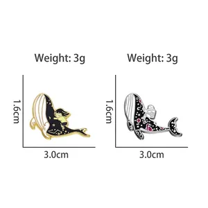 Whale enamel pins with girl and astronaut designs in gold and silver finish