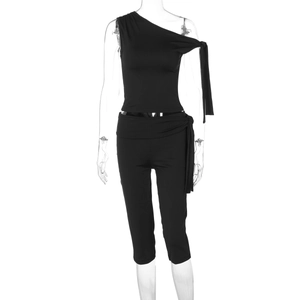 Detail view of black one-shoulder tie-up top and slim matching high-waisted capri set
