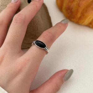 Macro shot of 925 sterling silver ring featuring an oval black onyx gemstone inlay