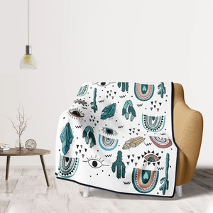 Detail of white flannel blanket featuring bohemian cactus, rainbow and eye patterns