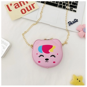 Detailed view of pink cartoon crossbody bag for kids with gold chain on creative desk