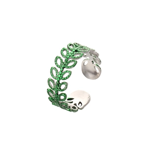 Detailed macro of adjustable silver leaf ring with vibrant green crystal settings