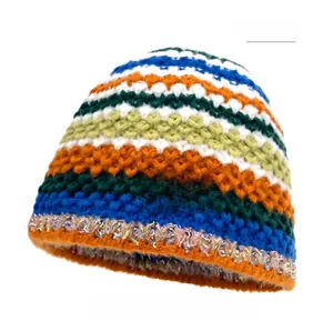 Detailed close-up of rainbow striped knit beanie featuring a Love Fashion woven label