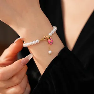 Elegant gold plated pearl bracelet with pink dragon fruit charm and adjustable lobster clasp