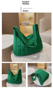 Detail of green quilted space cotton tote bag with puffy texture and wide shoulder strap