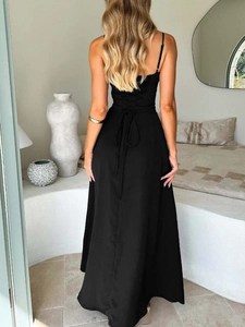 Detail view of black strap maxi dress with cross-back lace-up design and high slit