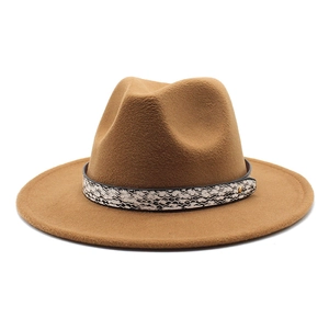 Detail of khaki wool fedora hat featuring a stylish snakeskin band and metallic buckle