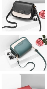 Close-up of stylish color-block crossbody bags with decorative bear pendant and metal clasp