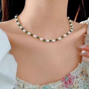 Elegant Chinese style necklace with white pearls, green beads and golden metal spacers