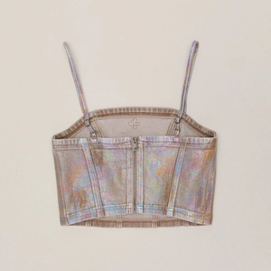 Detailed back view of iridescent metallic denim camisole with metal zipper and adjustable straps