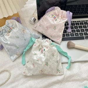 Cute cartoon bear drawstring storage bags in pink, blue, and white soft fabric