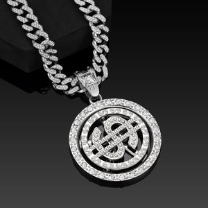 Close-up of hip hop spinning dollar pendant with sparkling rhinestones on silver Cuban chain