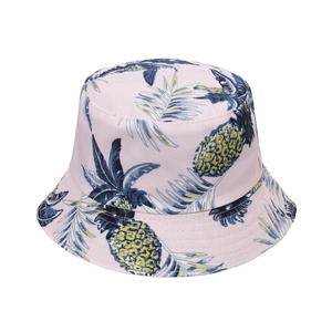 Close-up of pink bucket hat featuring tropical pineapple and palm leaf print detail