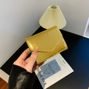 Fashionable gold metallic envelope wallet in glossy finish for stylish women
