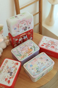 Detail of assorted rectangular tin boxes featuring rabbit illustrations and sweet life themes