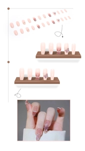 Detail of pink gradient press-on nails with 3D butterfly, pearls and glitter accents