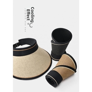 Foldable straw sun visor showing how to roll and pack it for easy travel storage