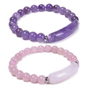 Fashionable crystal beaded bracelets with amethyst and rose quartz stones on white background