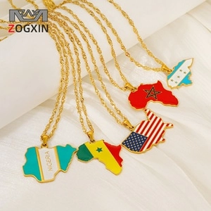 Macro view of gold-plated map pendant necklaces featuring colorful national flag enamel