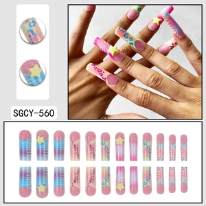 Y2K style press on nails featuring long square shape with rainbow patterns and stars