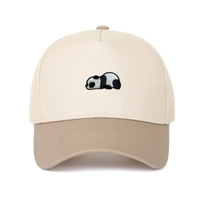 Close-up of embroidered panda patch on two-tone beige and khaki baseball cap