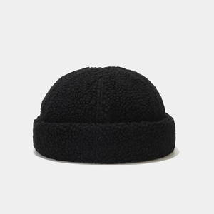 Close-up of black lamb wool docker hat featuring soft plush texture and warm rolled edge