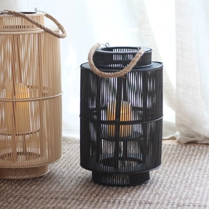 Handwoven bamboo lanterns with rope handles and warm electronic candles for home decor